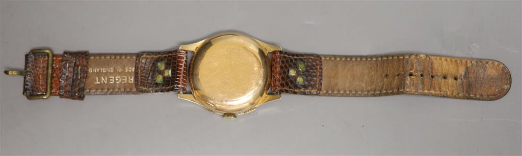 A Swiss 18k yellow metal chronograph manual wind wrist watch, on associated leather strap, with a Garrard & Co box.